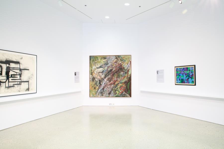 A gallery corner featuring large-scale abstract paintings and information panels.