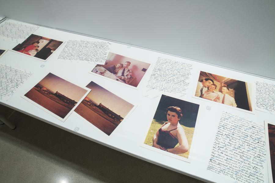 A display case featuring vintage photographs and handwritten letters.