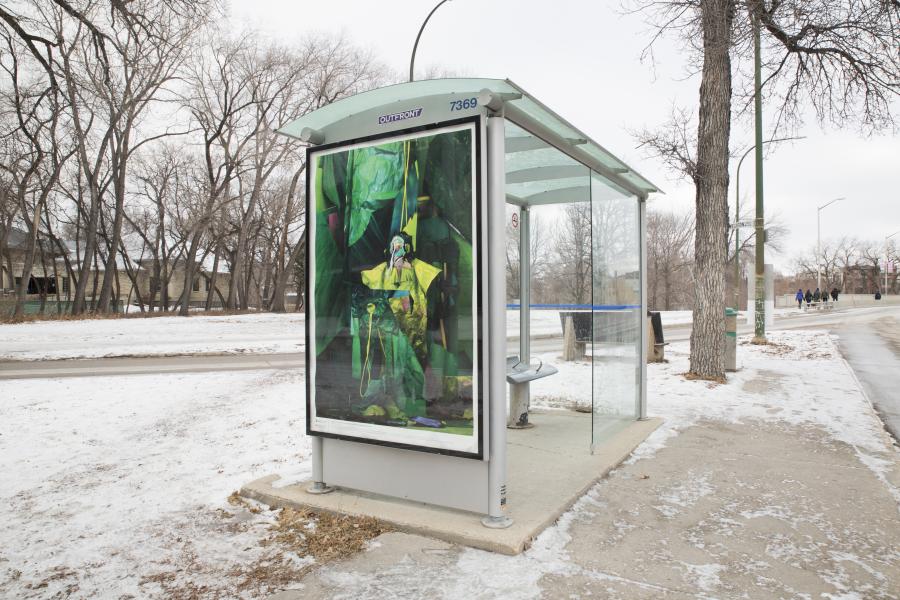A bus shelter in a snowy urban setting displays a large, surreal green-toned artwork featuring a figure in a theatrical pose with draped fabric.