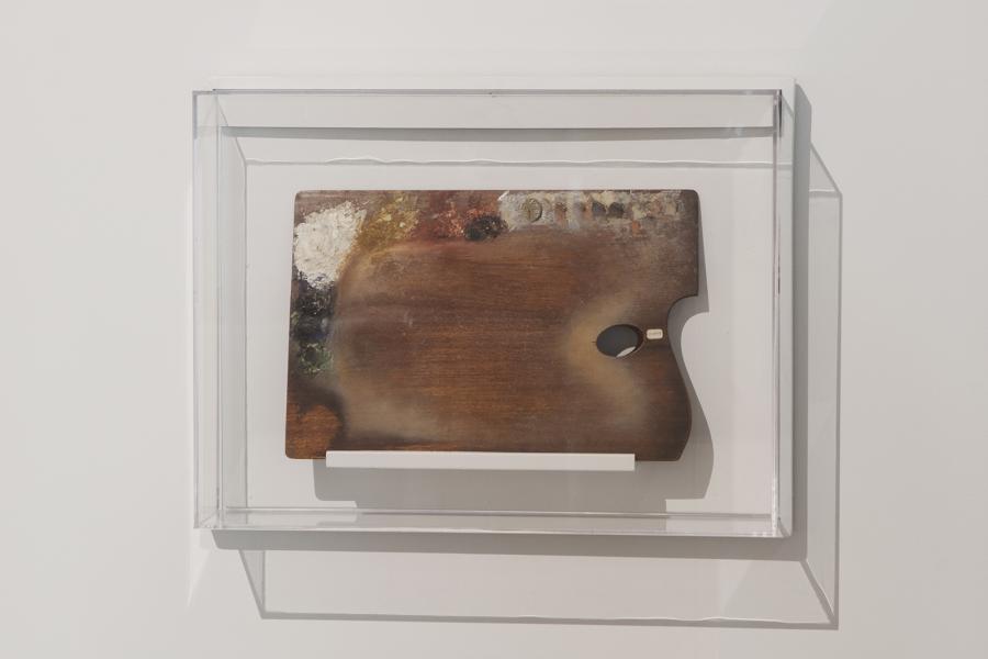 Framed painter’s palette with visible aged paint and organic growth.