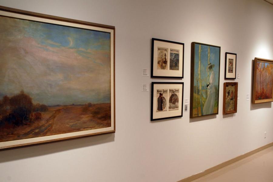 A wall of paintings. From left to right: an autumn prairie field and cloudy sky, two pairs of Motor / Motor-Sport magazine covers, a woman in white clothing in front of white tree trunks and a green valley, two versions of a canoe in rushing water, and an autumn forest.