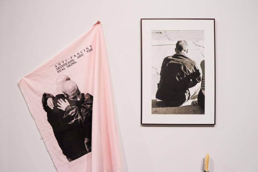 Installation featuring a printed textile and framed photograph.