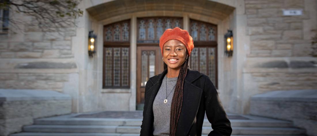 Victoria Nwabuis a Faculty of Arts student and recipient of the Alumni Association’s Community Leadership Scholarship stands in front of the Tier Building. 