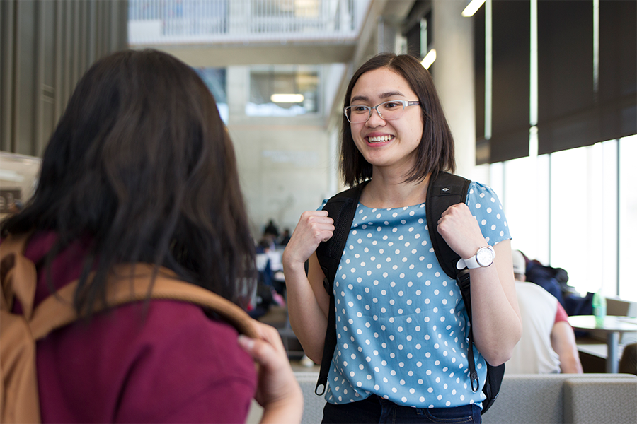 Students talking at a hallway.