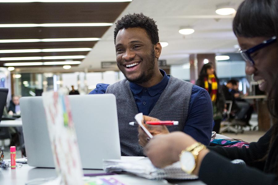 A student studying with his friends.