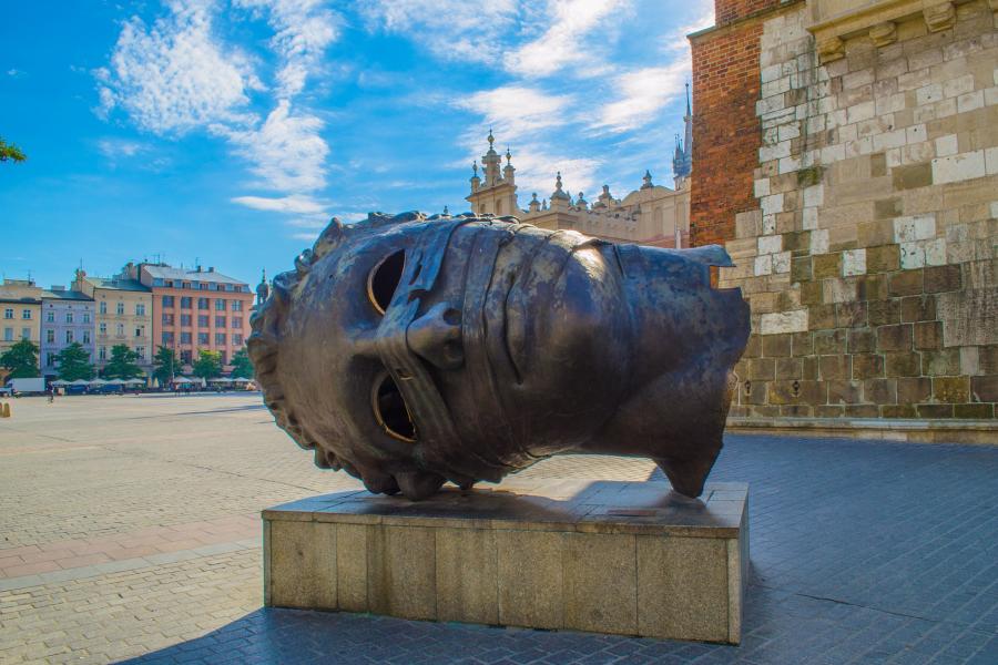 Large metal sculpture of a head laying on it's side in Krakow, Poland.