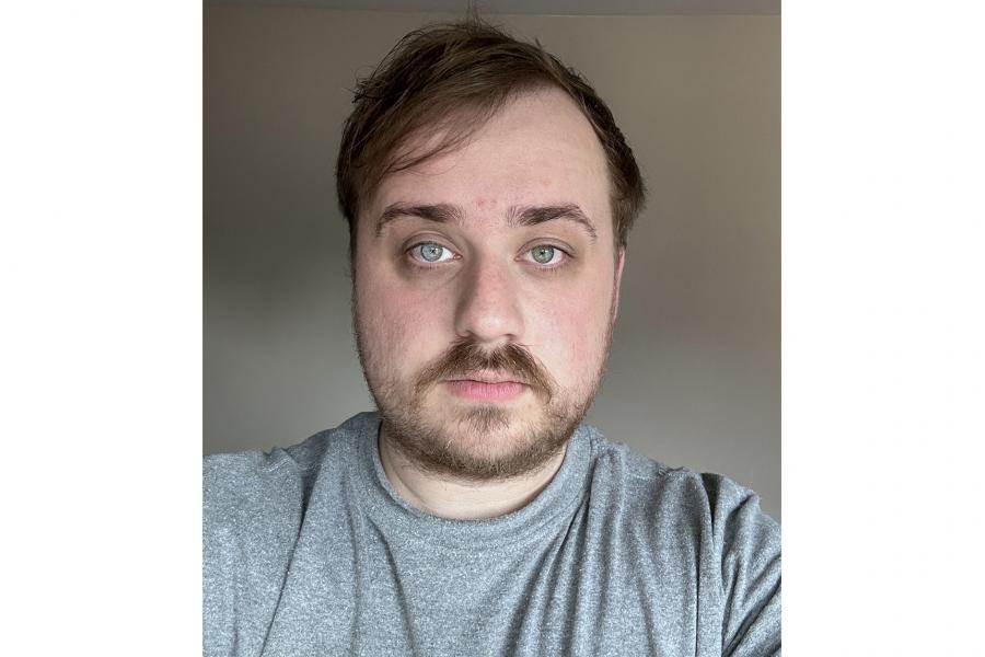 Headshot of Andrew Dvorak wearing light grey tshirt.