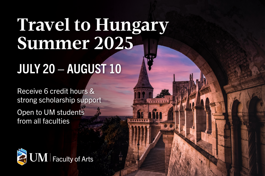 View of a European castle through a covered stone bridge.