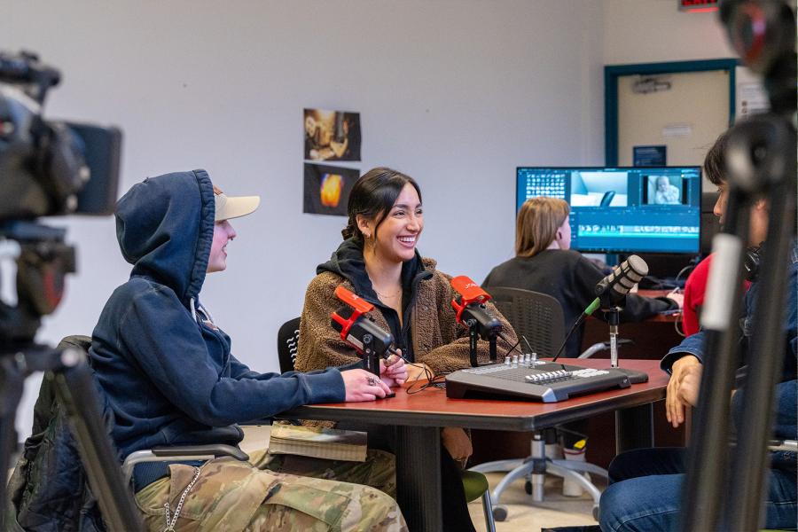 A group of students excited and working on group podcast session