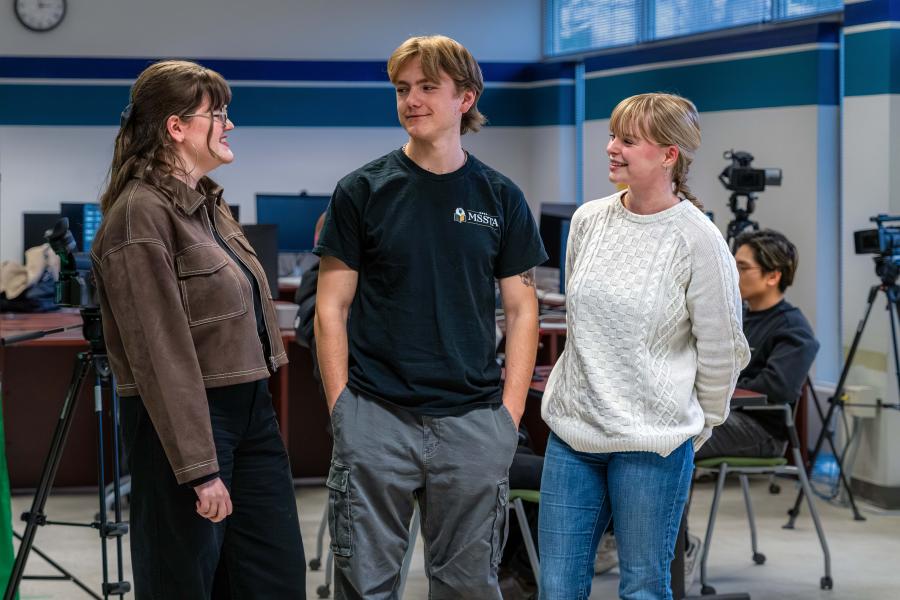 A group of students chatting in the media lab