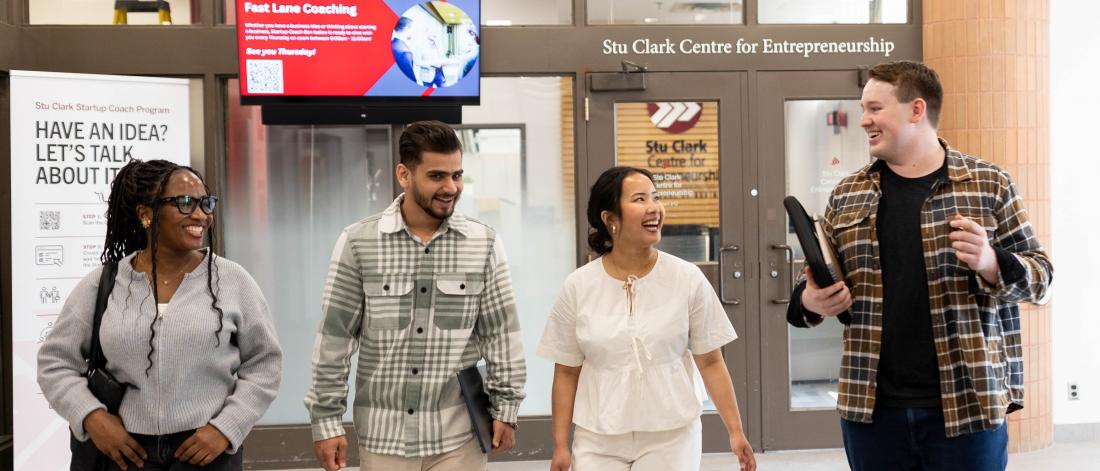 Students working and talking about the How to Start a Side Hustle Course