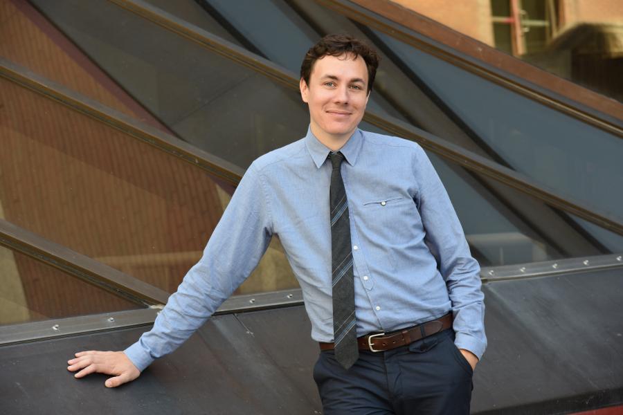 Assistant professor Sean Buchanan wearing blue shirt & tie