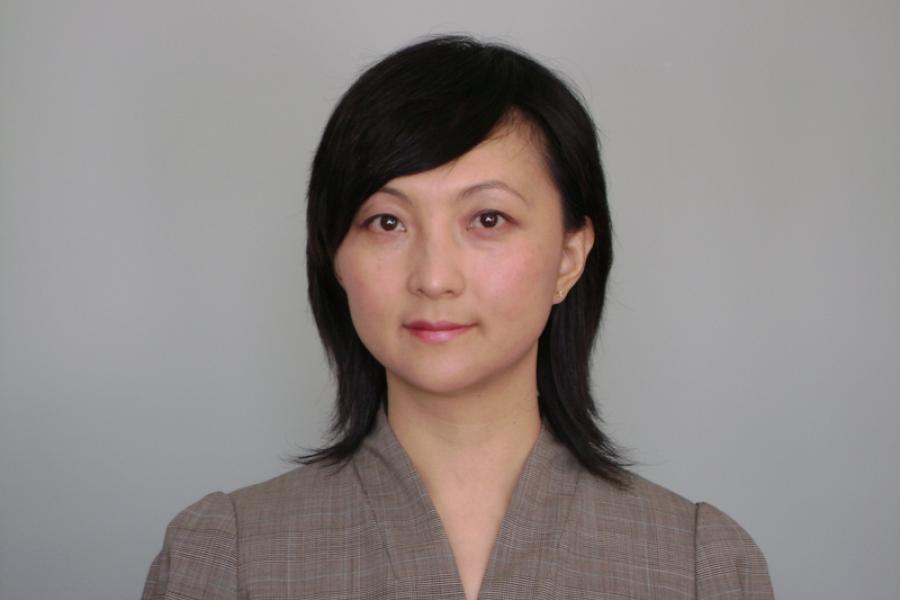 Photo of assistant professor Luming Wang. She has short dark hair and wears a grey shirt