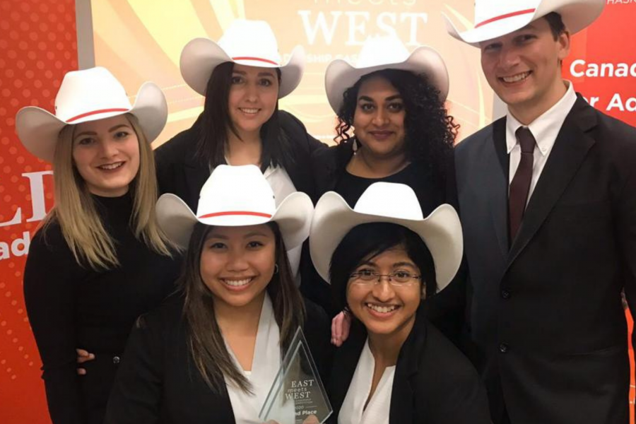 photo of a case competition team wearing cowboy hats