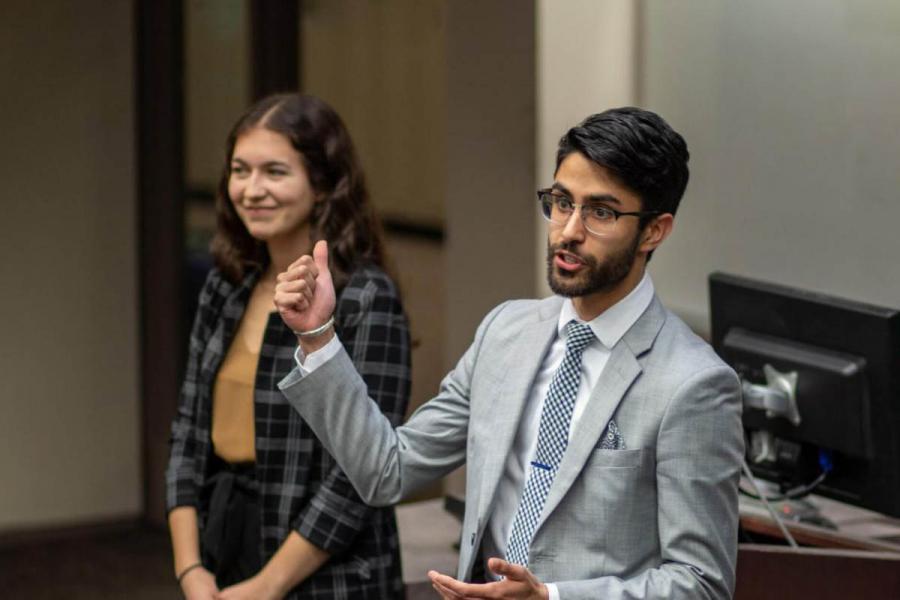 Two Asper School of Business students doing a presentation.