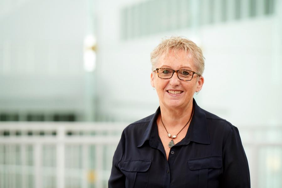 Colleen Loewen, Asper School of Business, wearing a necklace and blue button up shirt.