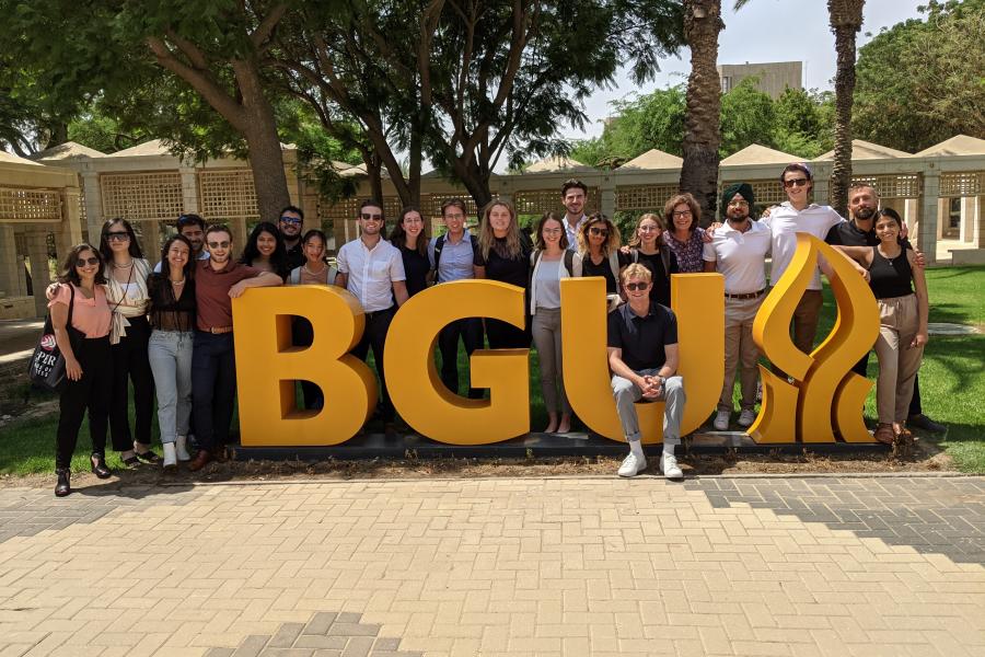 Students in front of a sign that reads BGU