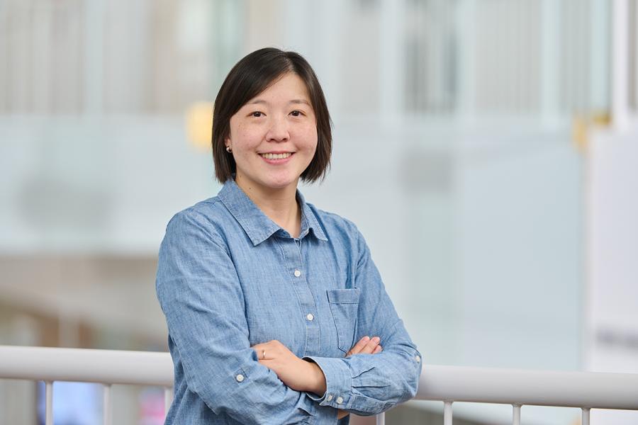 Image of an woman wearing a blue collared shirt. 