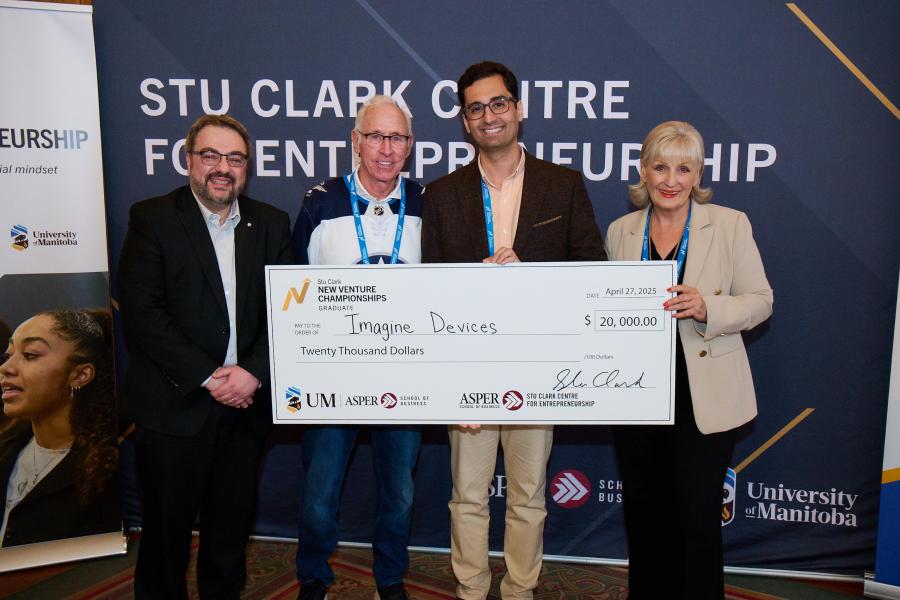 Graduate winner standing with Stu Clark and Executive Director