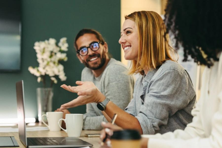New leader communicating at boardroom table.