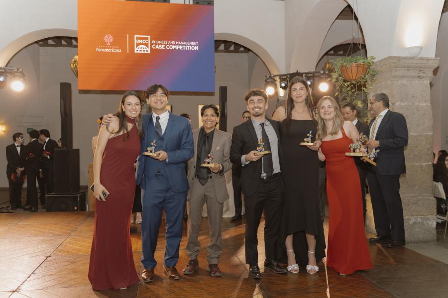 Winners of a competition pose with their trophies.