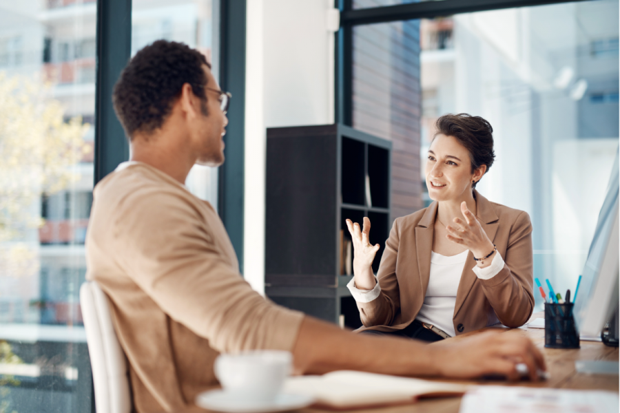 Woman coaching man in office environment