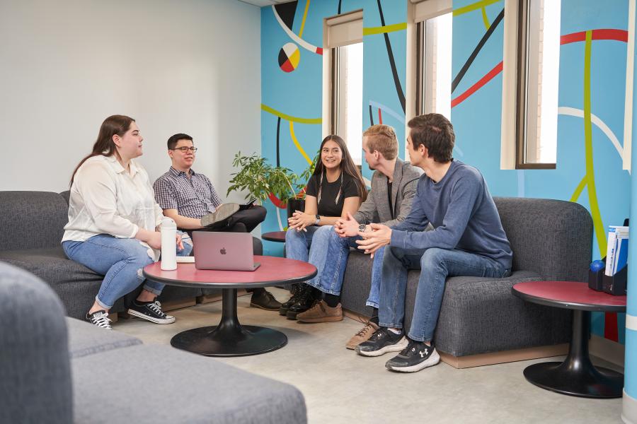 students talking in IBEP student lounge