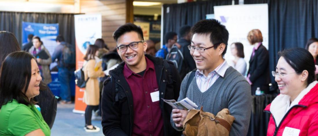 Students in a career fair laughing  