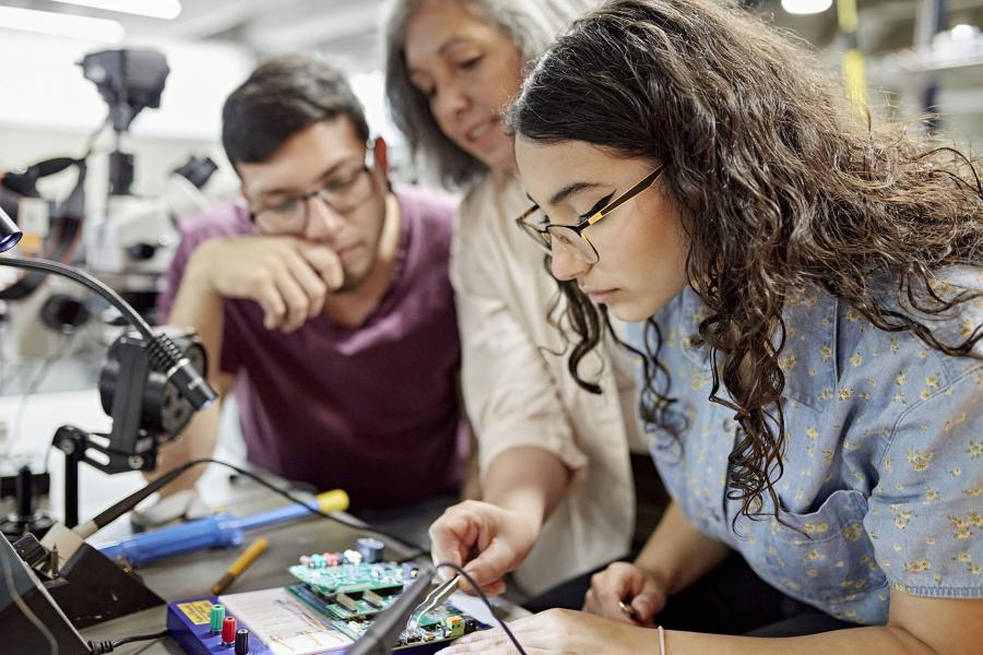 Students building a computer component.