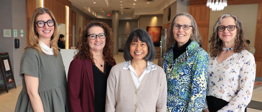 Centre staff, researchers, and support services to senior staff are smiling in a lobby
