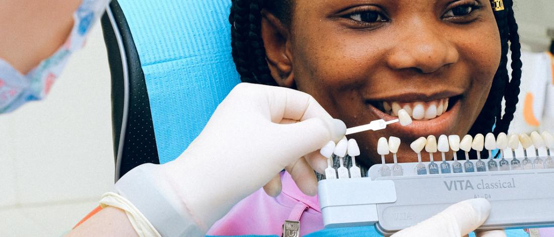Patient looking at a model of a dental implant.