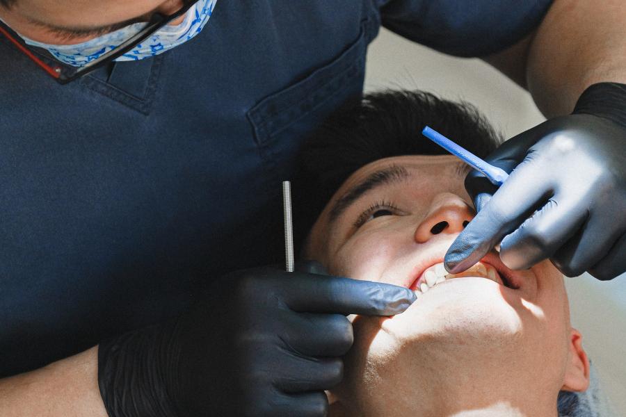 A dentist examines a patients teeth.