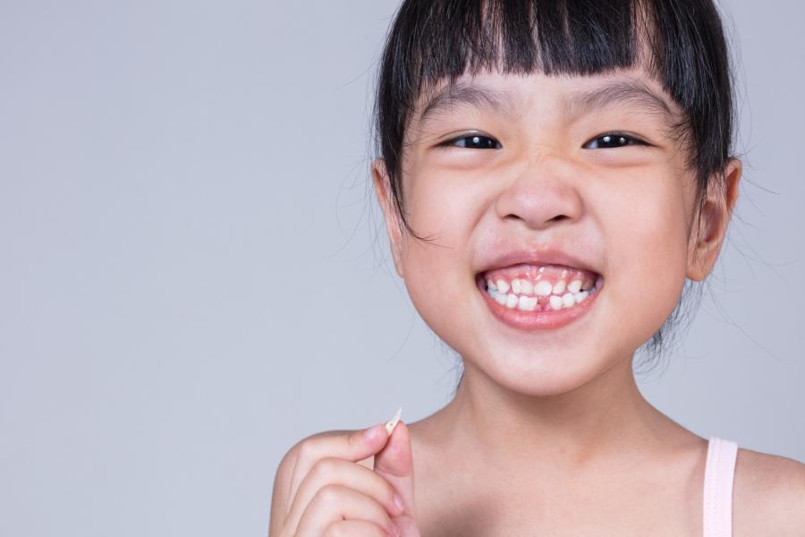 Child with a missing tooth.