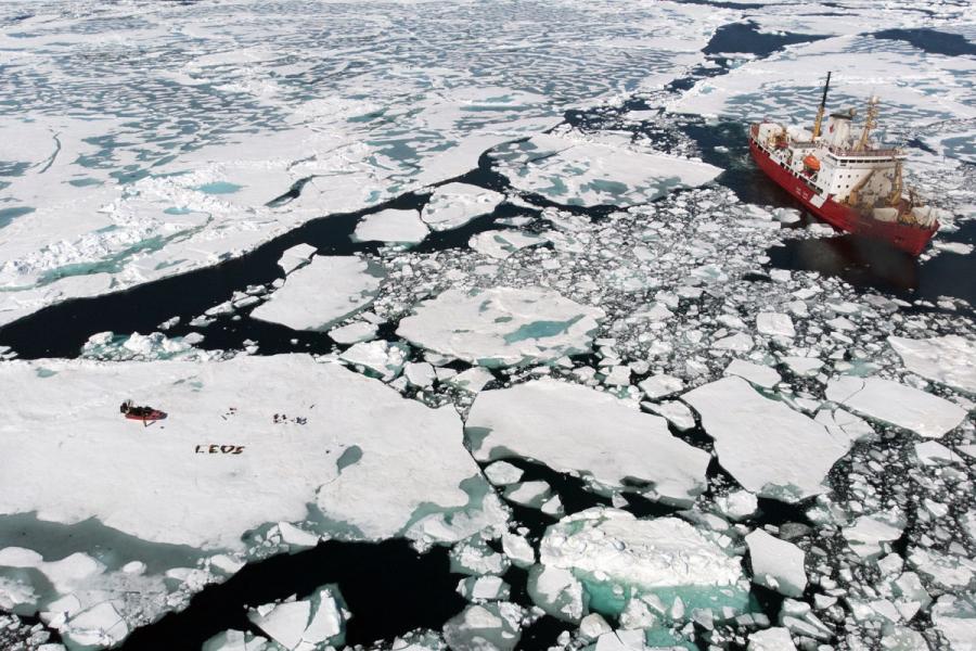 aerial view of baysys team laying on arctic ice to spell C-E-O-S.