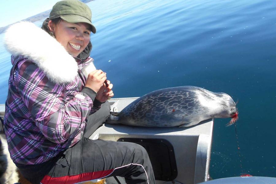 Enooyaq Sudlovenick with a seal.