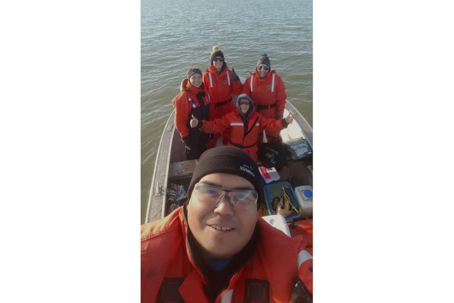 Scientists and deckhands from the MV Namao pose for a picture on a workboat.