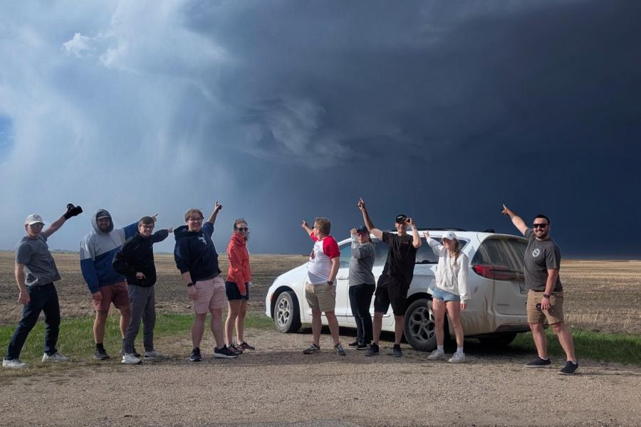 Students pointing at storm cloud