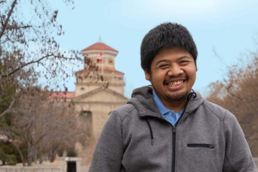 student with intellectual disabilities in front of university building