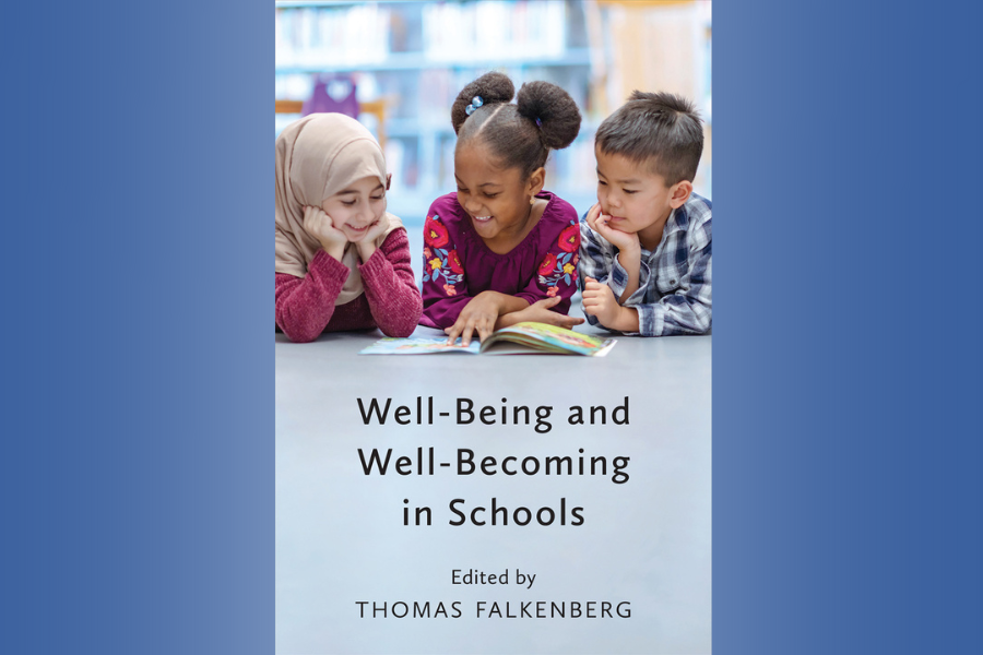 cover of book with young children looking at a book, smiling