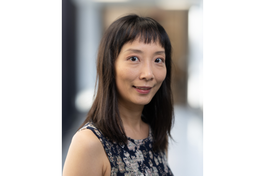 headshot woman with dark hair and bangs
