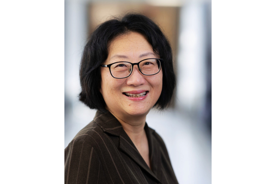 woman head shot with chin length dark hair and glasses