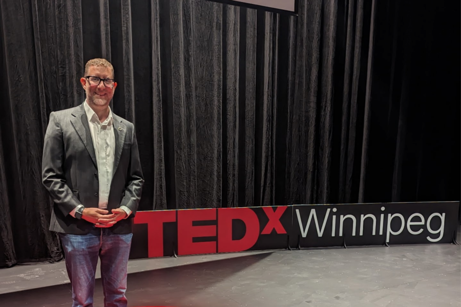 Robert Mizzi in front of Tedx sign