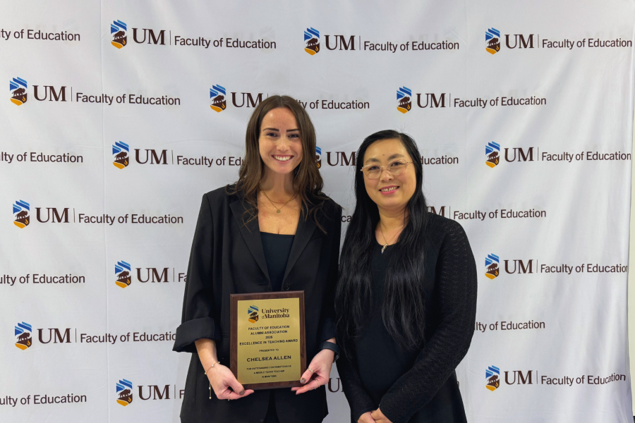 graduate student standing with faculty member