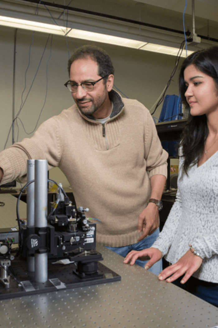Sherif Sherif works in his lab with a student.