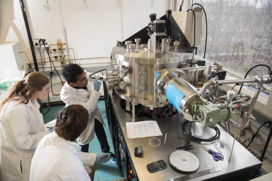 Three researchers working in the nano systems fabrication laboratory.