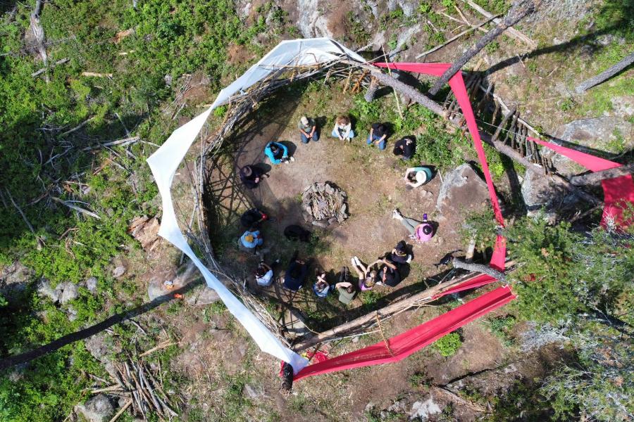 aerial view of circle of students in forest for land-based learning