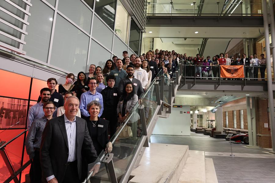 A large group of people posing on a staircase in the Engineering Atrium