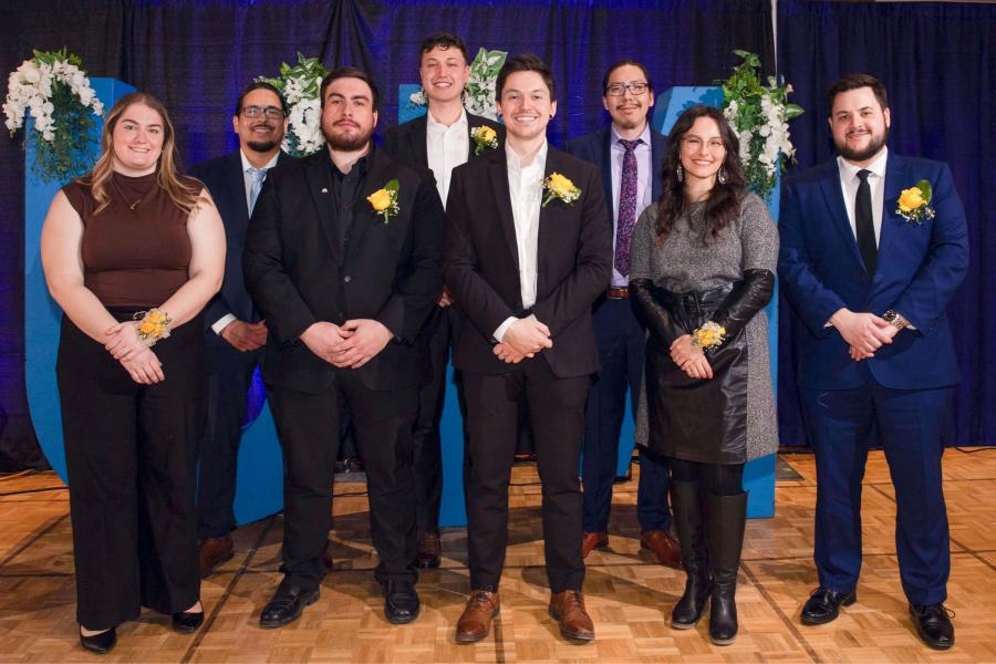 A group of people in formal wear smiling for picture