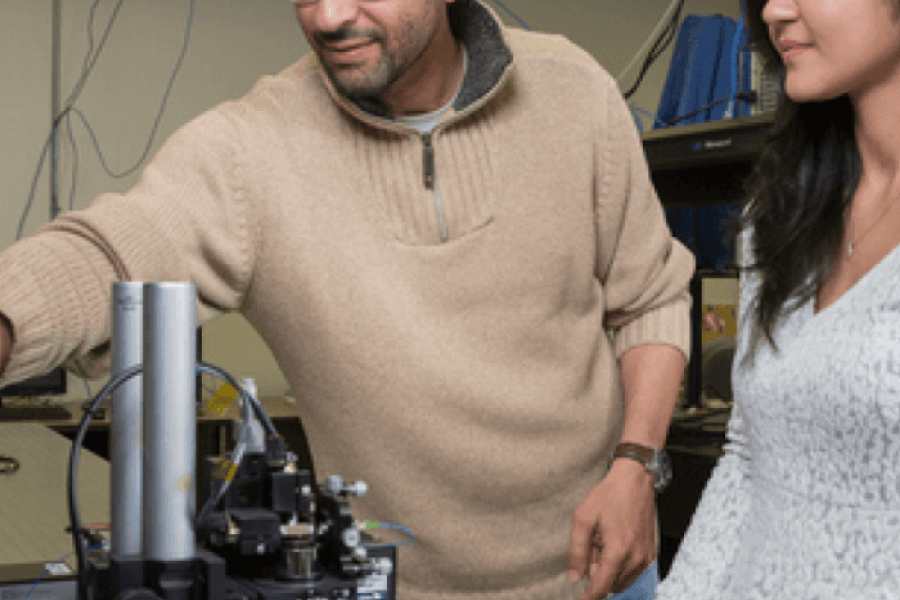 Sherif Sherif works in his lab with a student.
