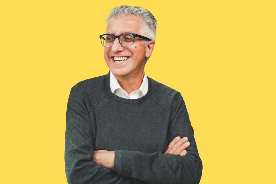 President Benarroch smiling with his arms crossed.